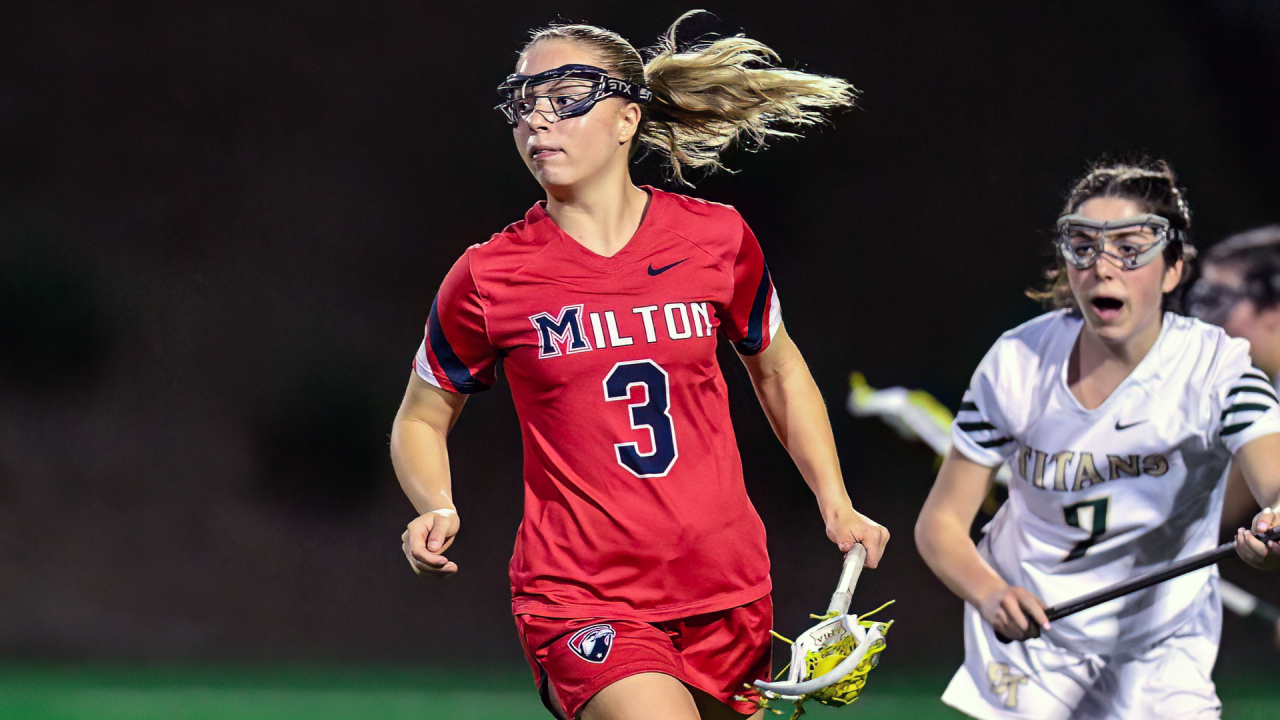 Kylie Waters of Milton (Ga.) girls' lacrosse carries the ball in her stick while running up the field