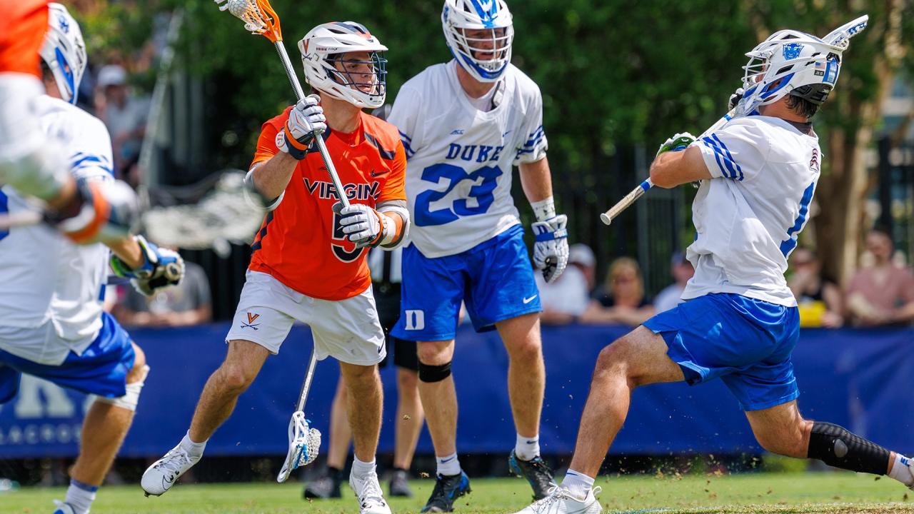 Virginia's Joey Terenzi looks at the goal in close surrounded by Duke players.