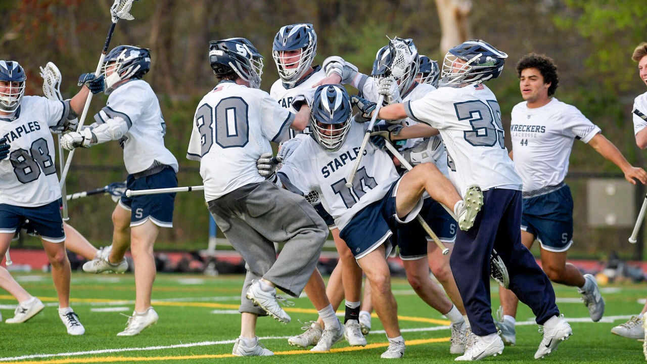 Staples (Conn.) lacrosse players celebrate after victory over New Canaan (Conn.)