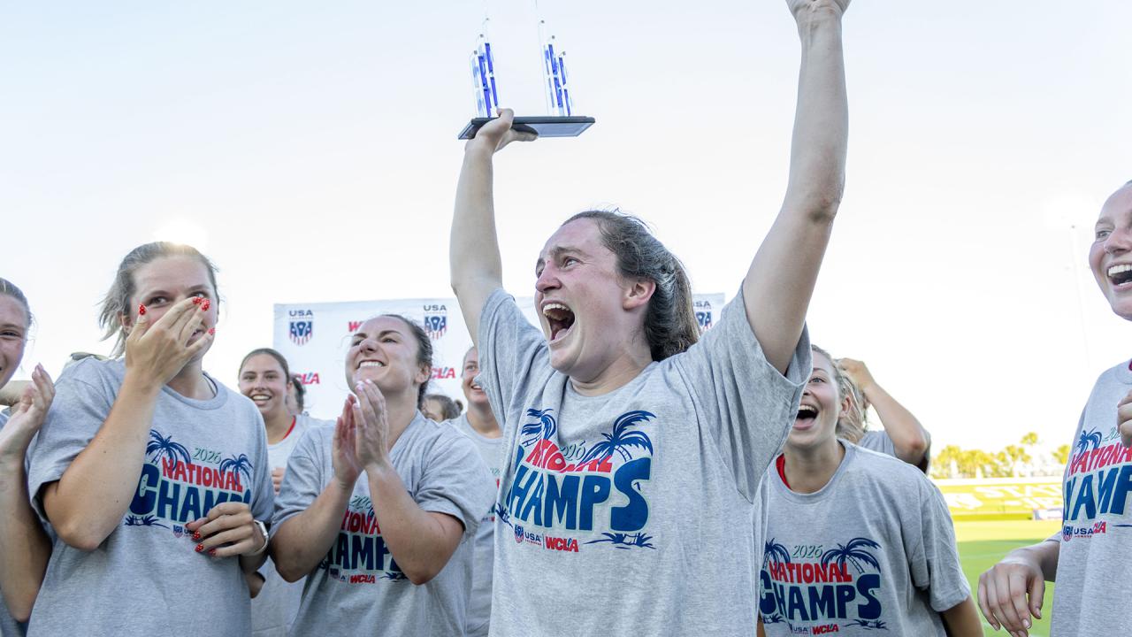 Georgia all-tournament defender Alex Young hoists the championship trophy after Georgia won the WCLA championship
