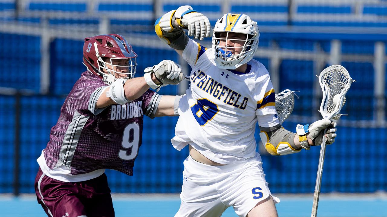 Springfield-Delco (Pa.) lacrosse player AJ Clark fends off a Broadneck (Md.) defender.