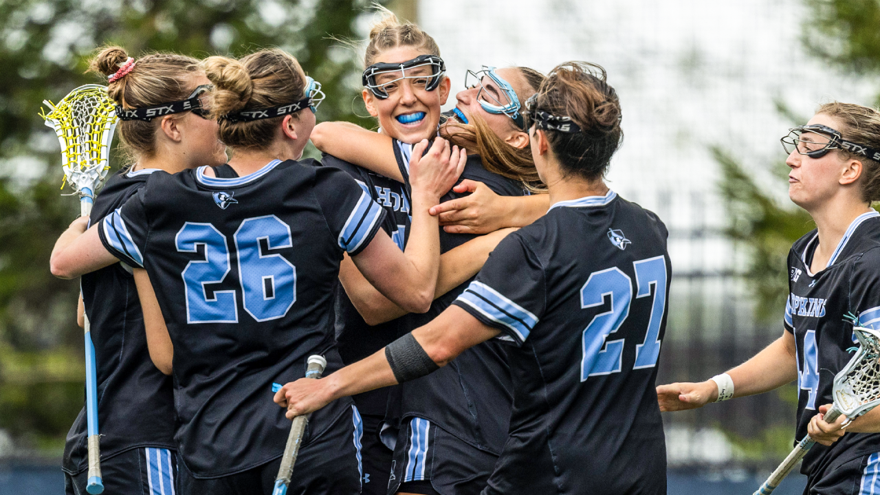 Hopkins' Ava Angello swarmed by teammates to celebrate a goal against Maryland in the Big Ten tournament