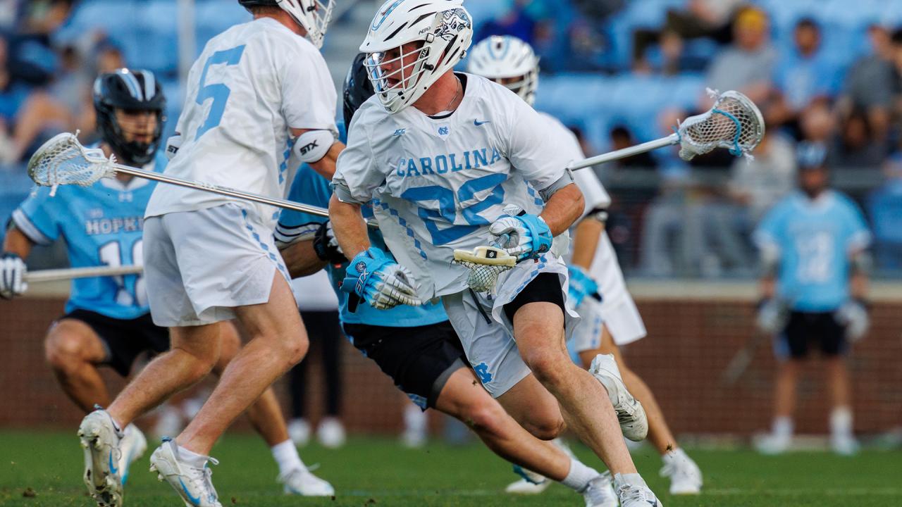 North Carolina's Brady Wambach with the ball after winning a faceoff against Johns Hopkins