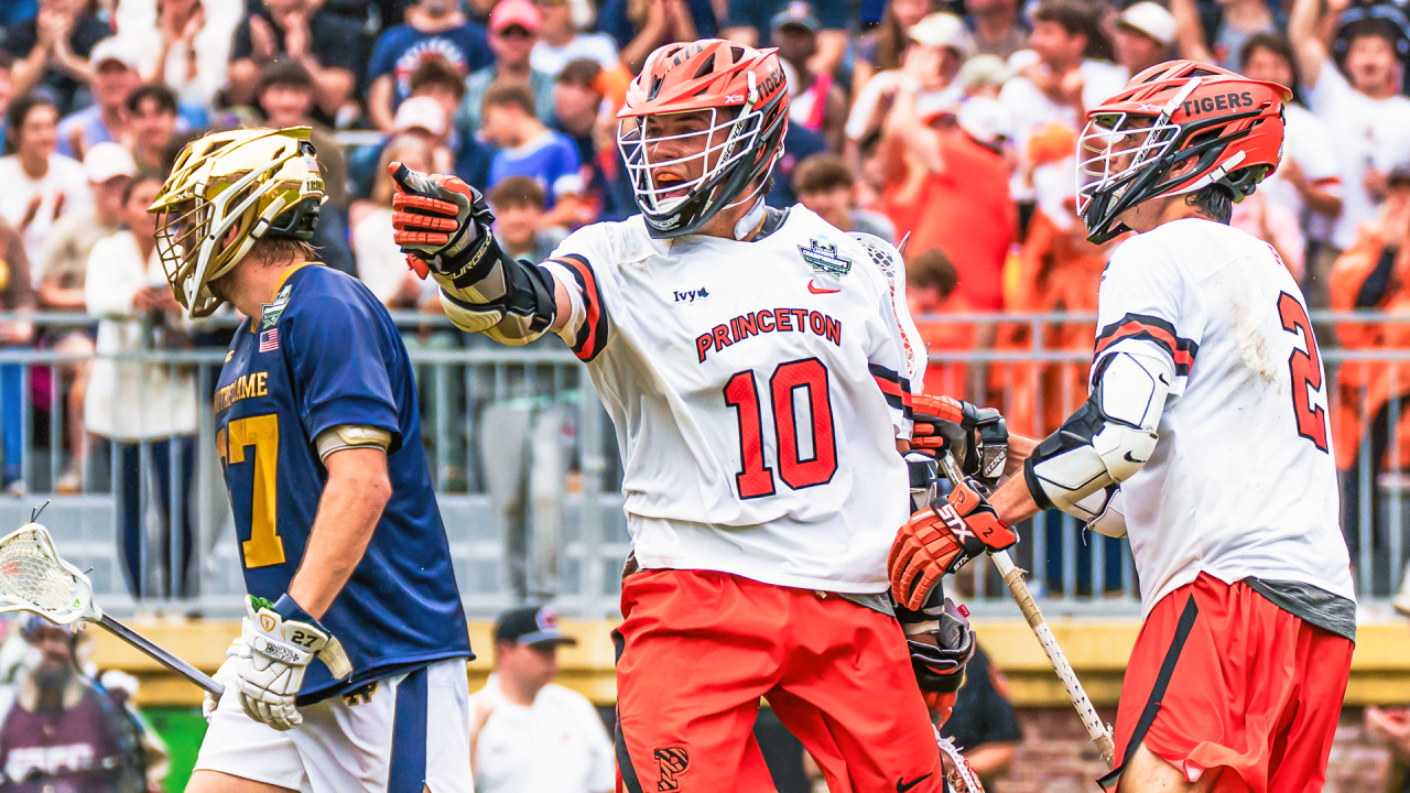 Chad Palumbo points at a teammate to celebrate after scoring one of his four goals in the national championship game at Scott Stadium