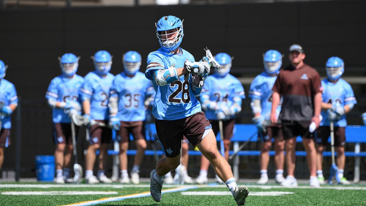 Chase Beyer of Tufts cradles the lacrosse ball