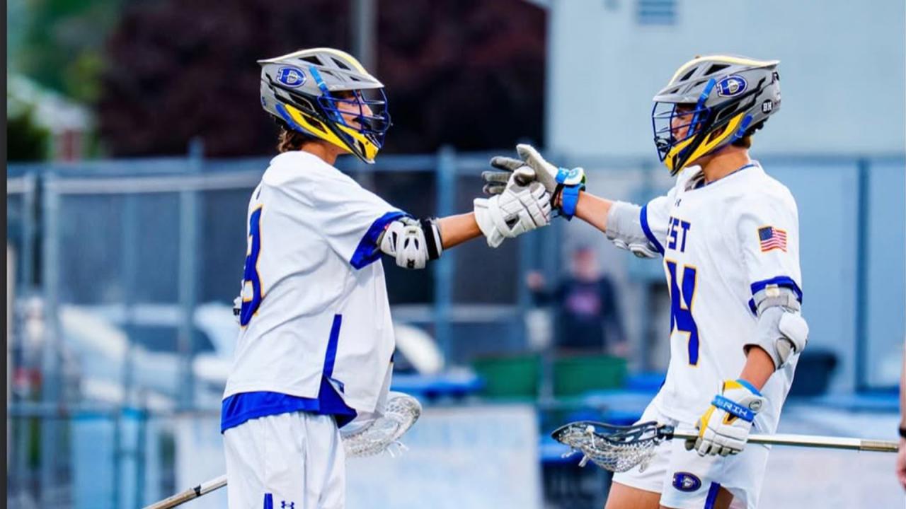 Downington West boys' lacrosse players celebrate a goal