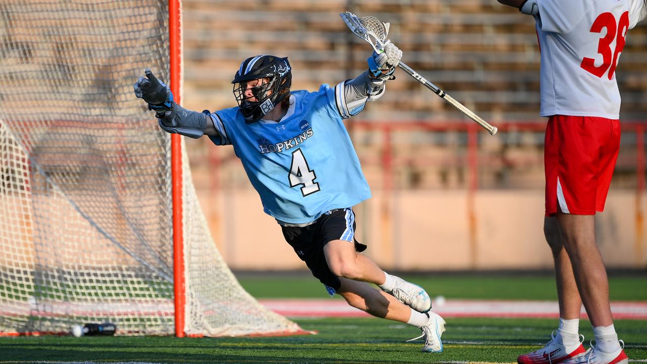 Jimmy Ayers celebrates with arms up after scoring the game-winning goal for Johns Hopkins.