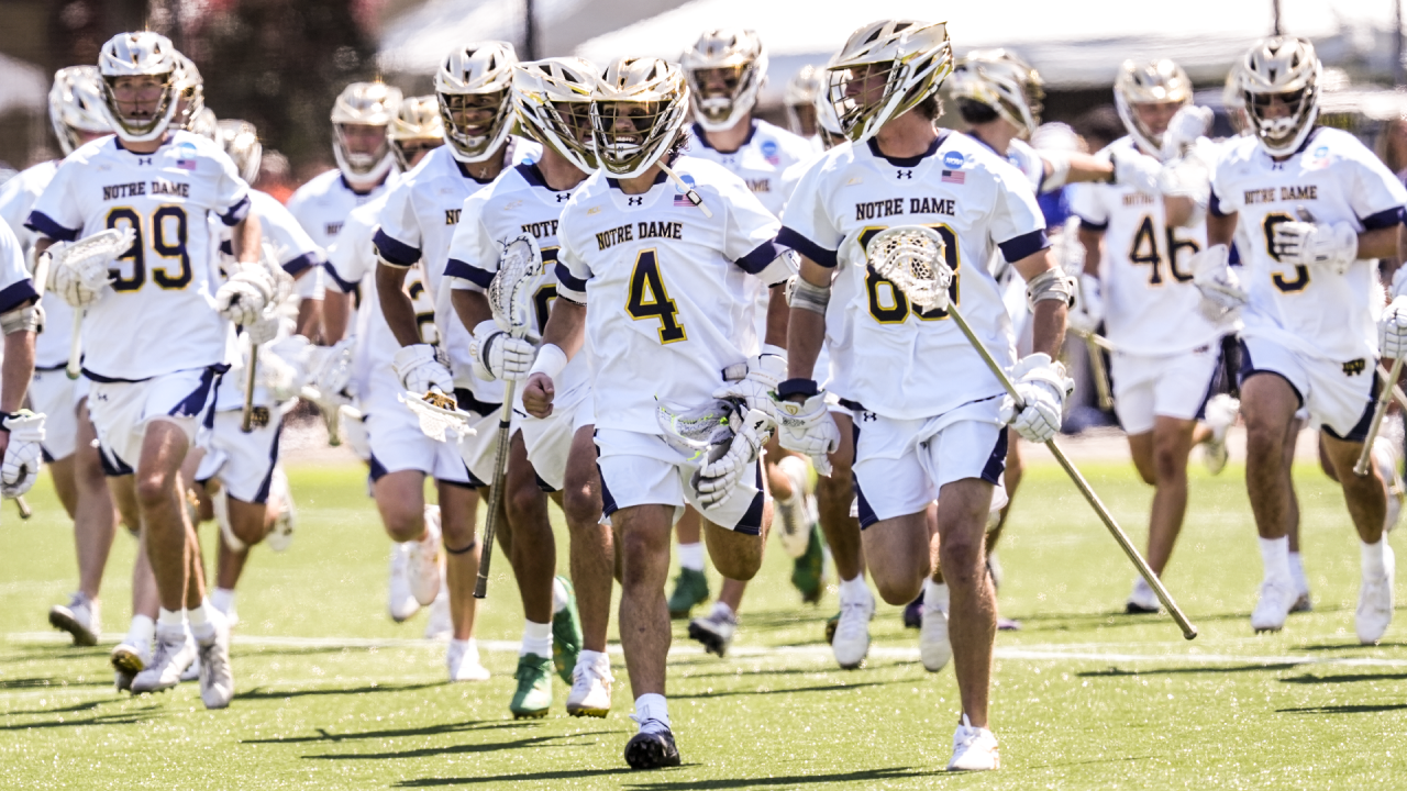 Matt Jeffery (4) leads a team celebration after Notre Dame's NCAA quarterfinal victory over Johns Hopkins at Hofstra
