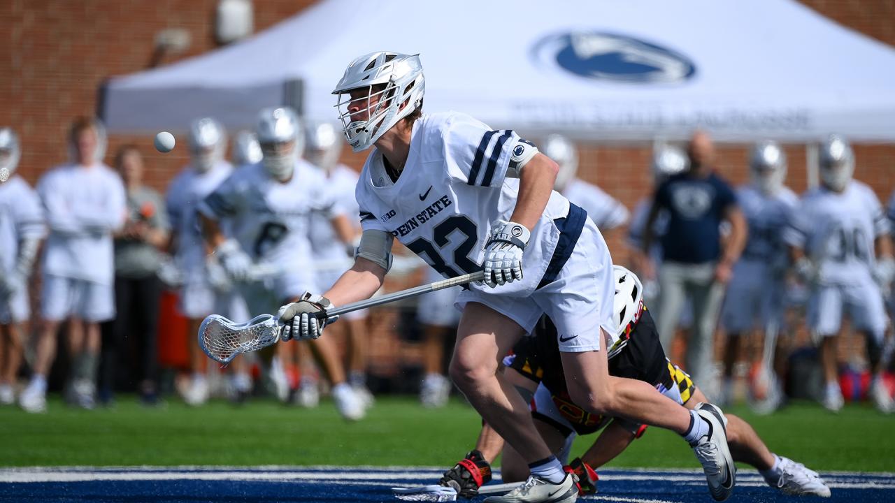 Penn State faceoff specialist Reid Gills pops the ball forward