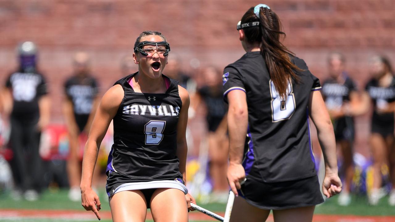 Sayville (N.Y.) girls' lacrosse players Carly Cangelosi (9) and Morgan Farrell (8) find each other to celebrate a goal in the state championship game at Cortland.