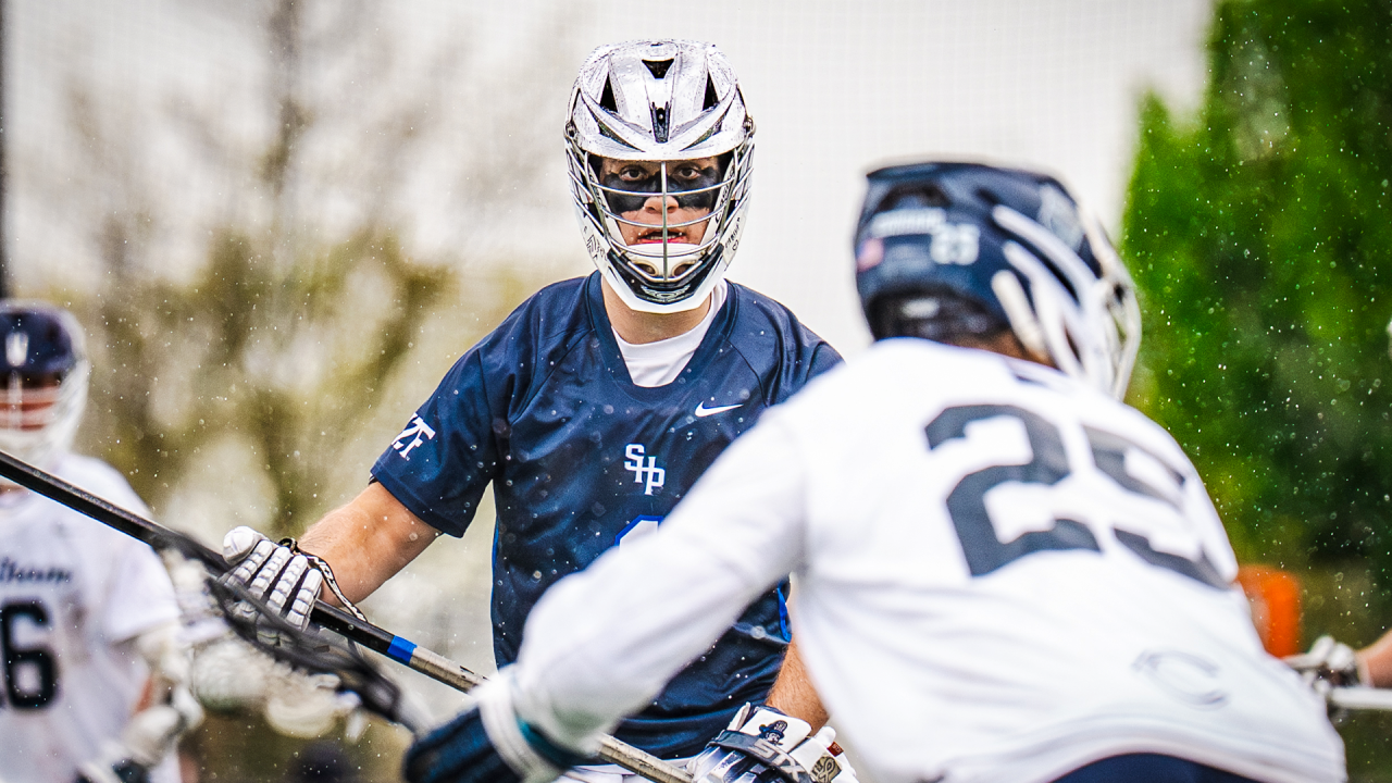 Seton Hall Prep (N.J.) lacrosse defenseman eyes ball carrier in a game