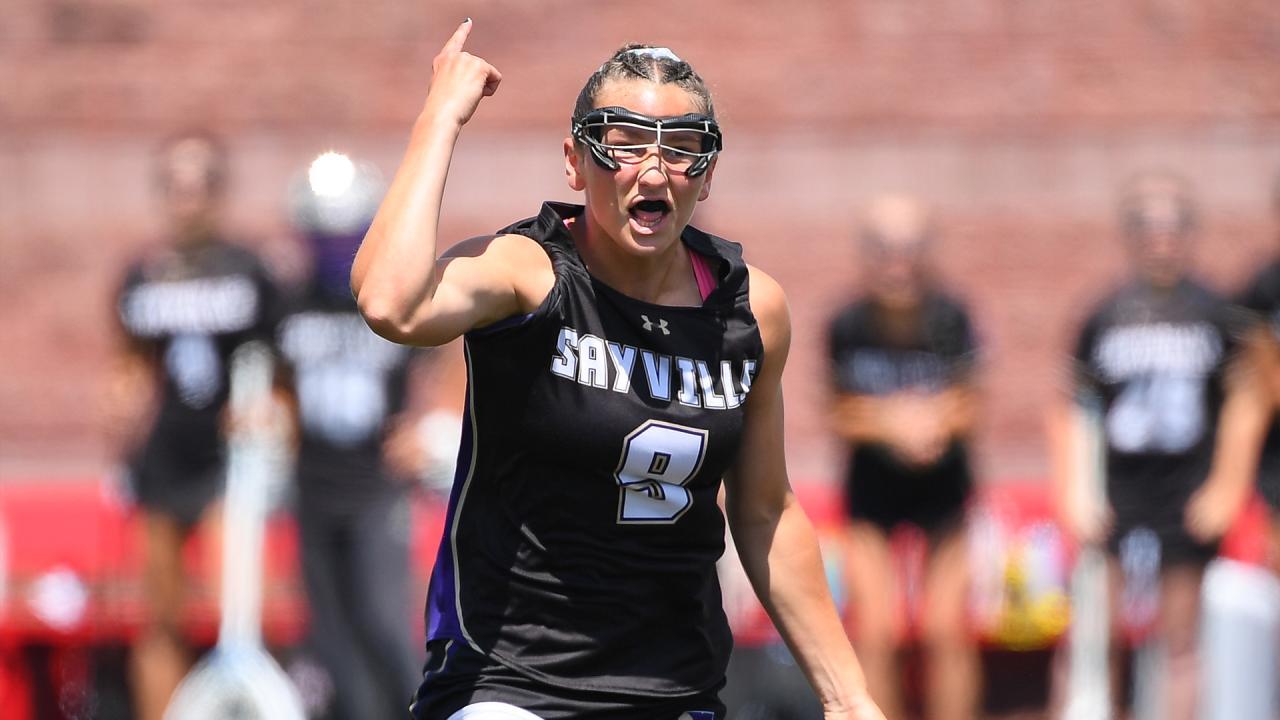 Sayville (N.Y.) girls' lacrosse player Carly Cangelosi (9) celebrates after scoring a goal in the state championship game at Cortland.