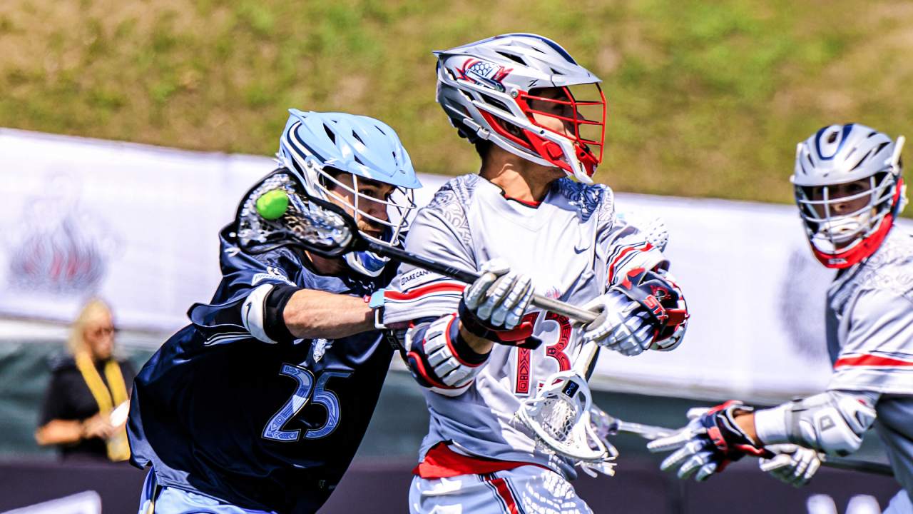 Jack Regnery of the Boston Cannons shoots as a New York Atlas defenseman Eli Gobrecht tries to thwart him in a Premier Lacrosse League game at Rafferty Stadium in Fairfield, Conn.