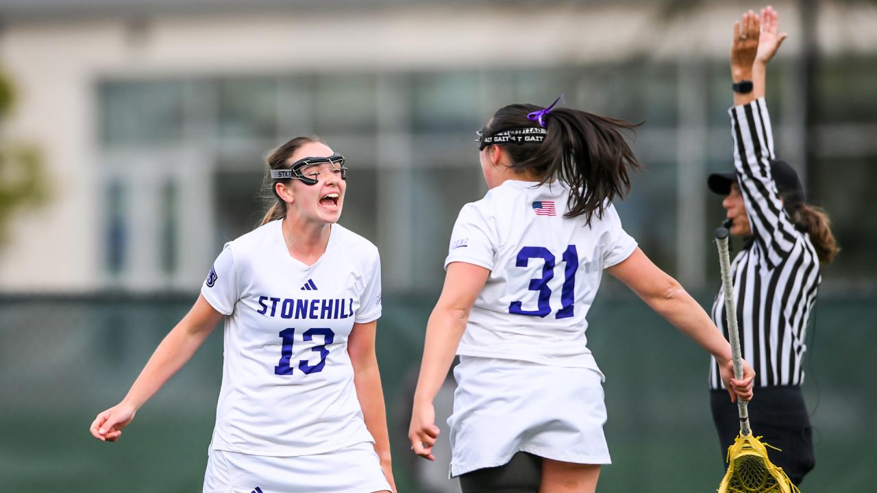 Stonehill women's lacrosse celebration after a goal in the NEC semifinals at Le Moyne