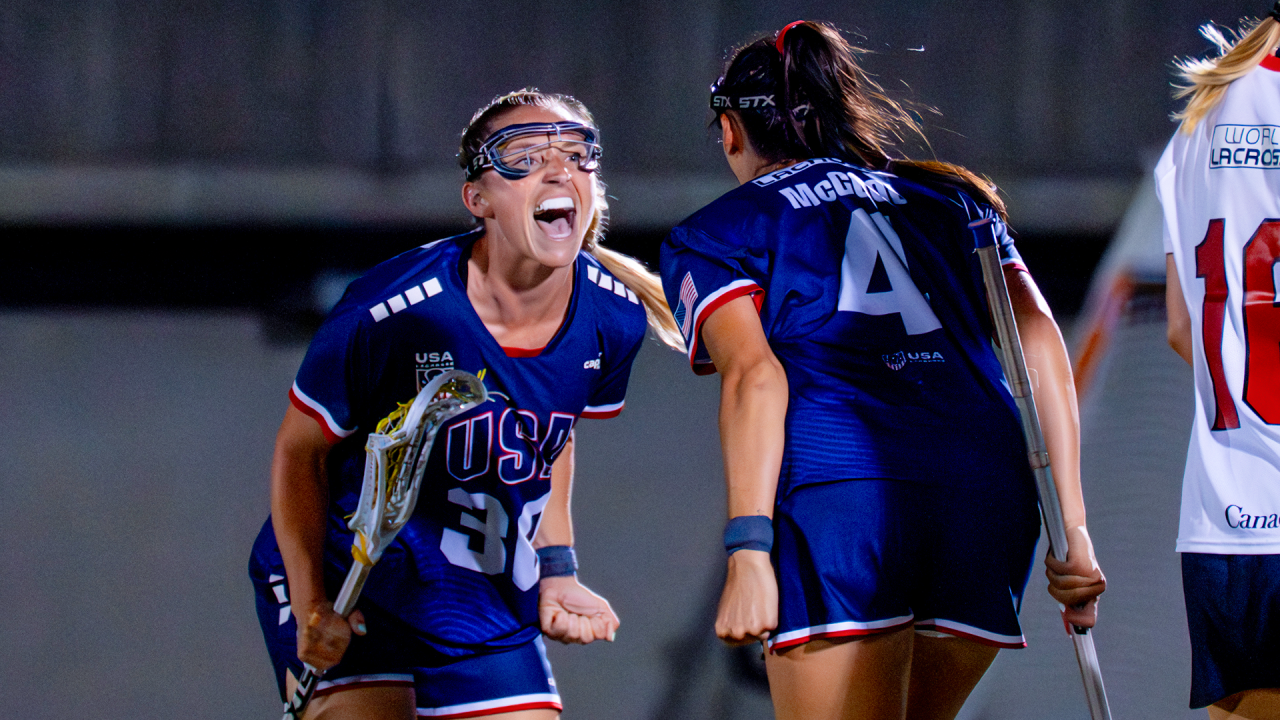 Ally Kennedy (30) and Marie McCool (4) celebrate after Kennedy's goal in the World Lacrosse Women's Championship gold medal game at Prince Chichibu Memorial Stadium in Tokyo, Japan.