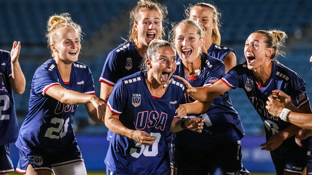 Ally Kennedy reacts in shock after being named World Lacrosse Women's Championship MVP as teammates 