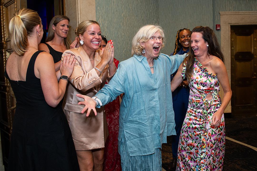Cindy Timchal celebrates with some of her past players and friends at the 2024 USA Lacrosse Foundation Gala