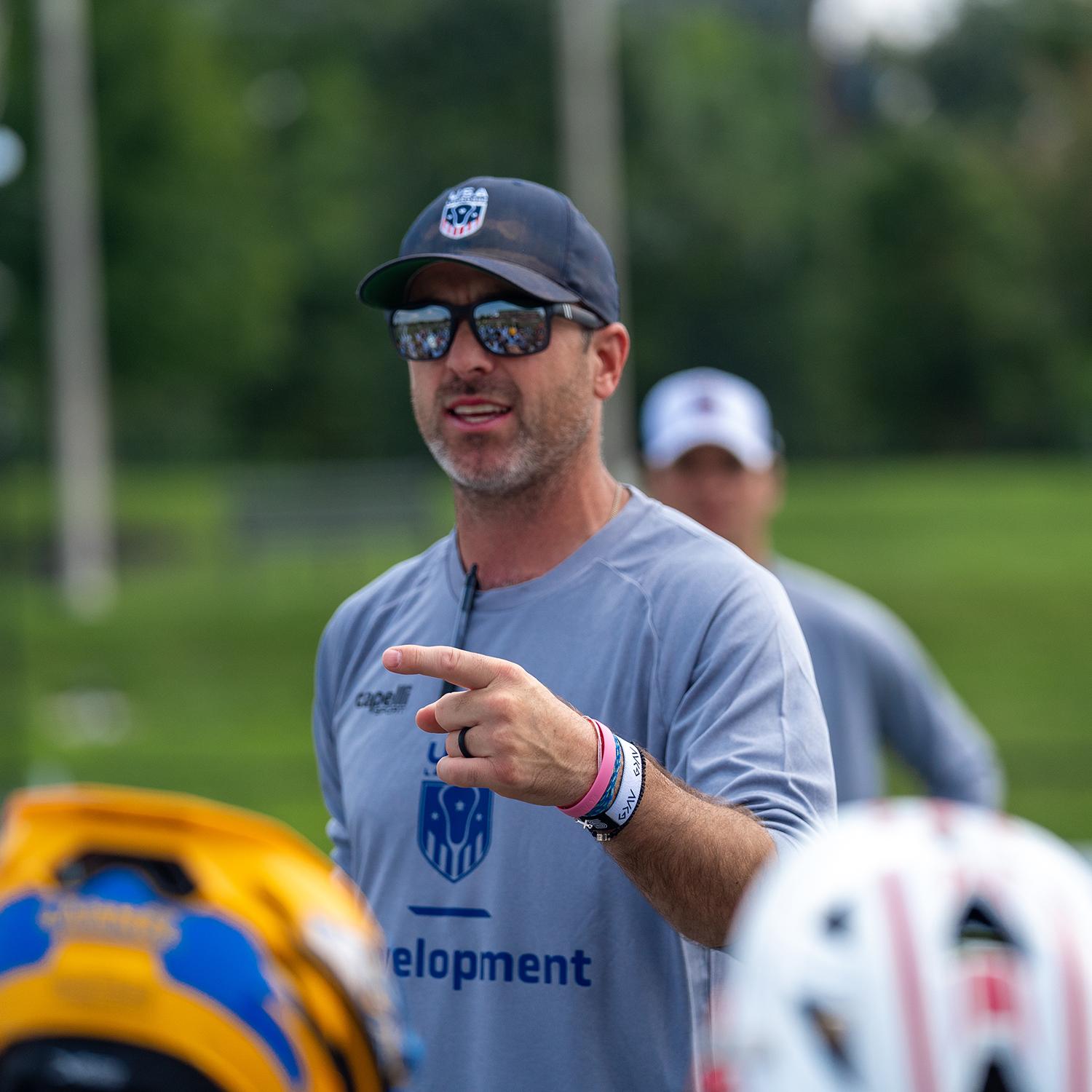 A lacrosse addressing his team