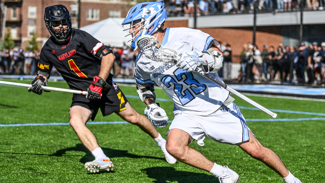 Johns Hopkins attackman Jacob Angelus (32) dodges against Maryland defenseman Ajax Zappitello (1) during a game earlier this spring at Homewood Field.